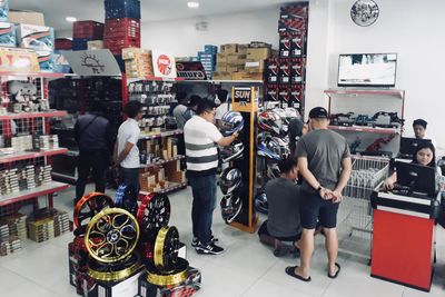 Customers browsing shelves of parts in the Innomoto store